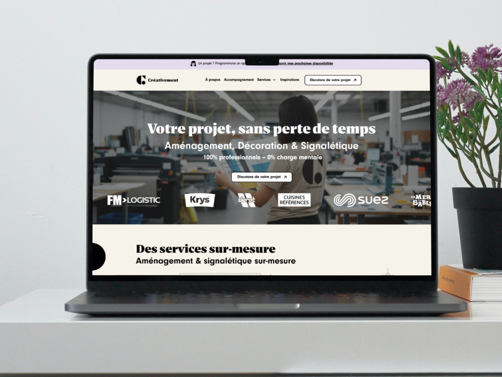 Laptop showing Créativement website with project services and company logos